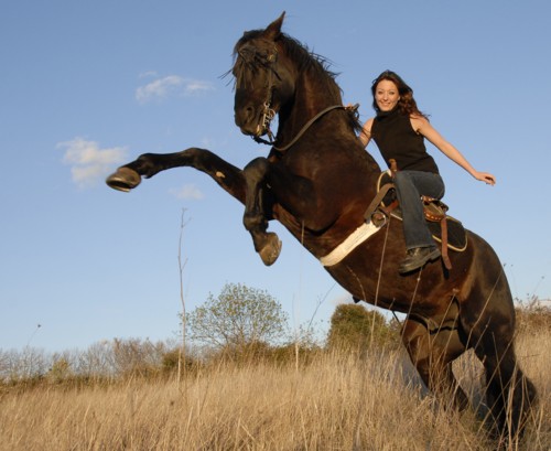 woman riding a much more powerful horse